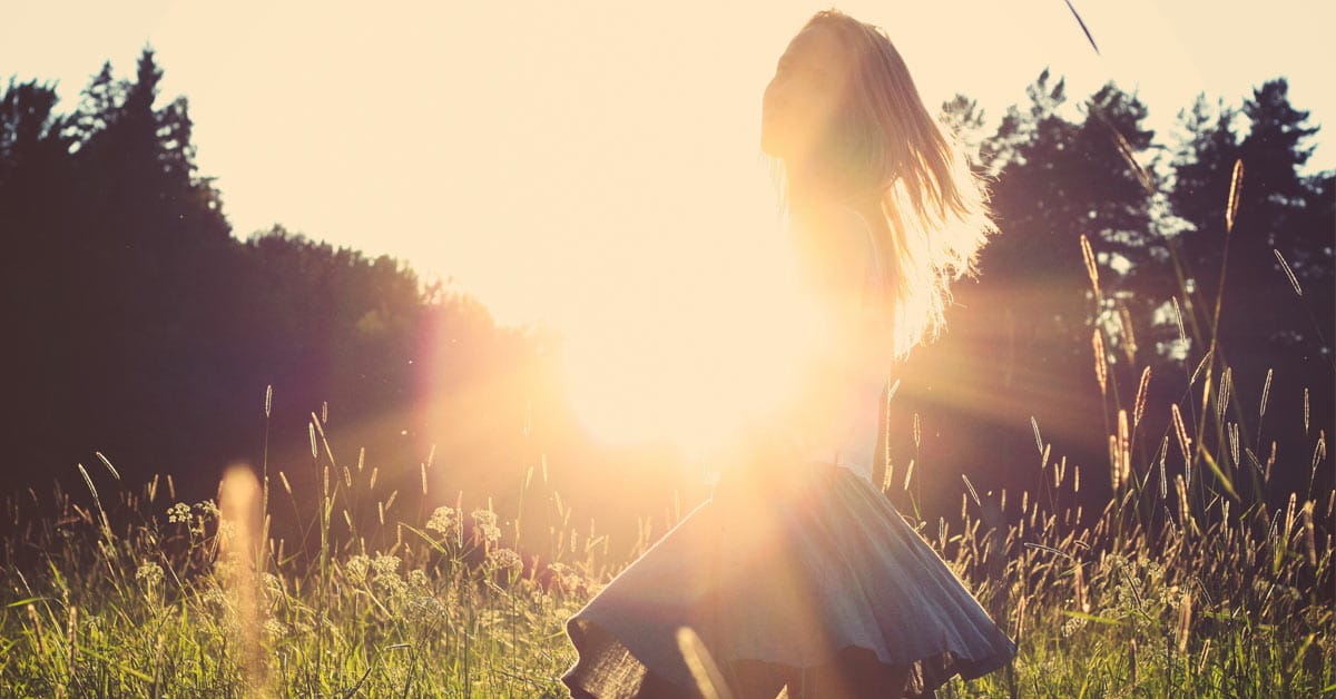 A woman basking in the sunlit field, a sign of doing well in life.