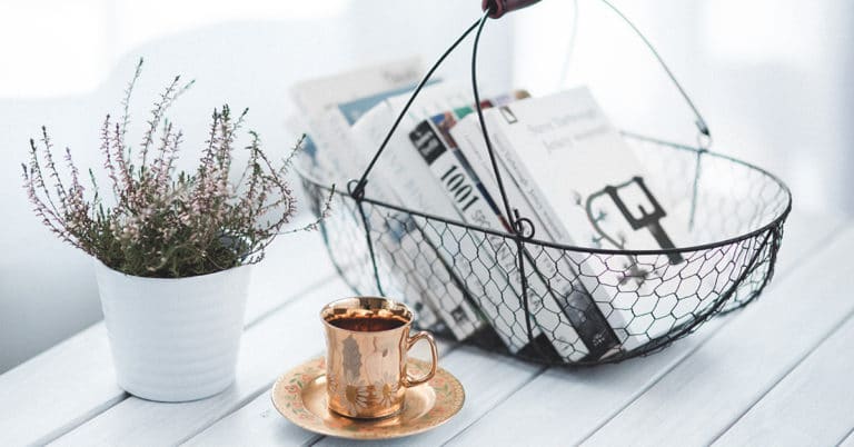 A table with magazines and a cup of coffee, creating a positive energy.