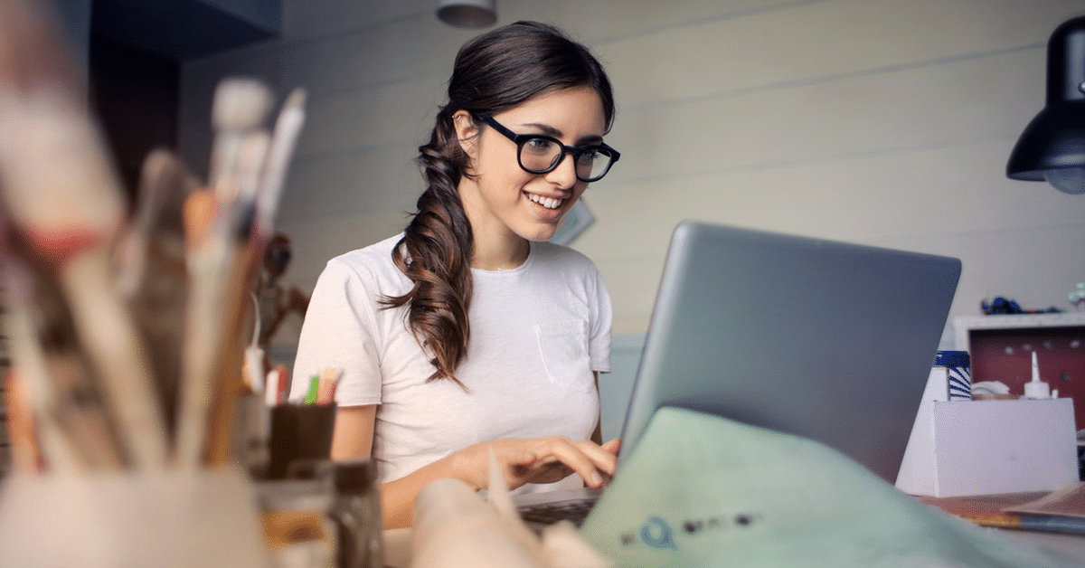 A woman is starting to work on a laptop.