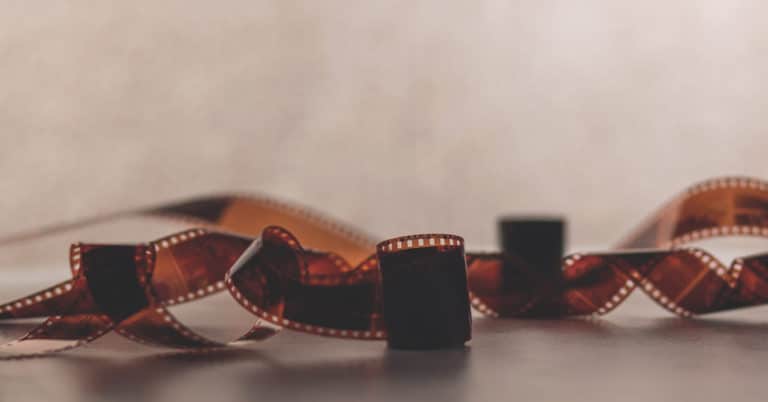 A stack of film strips on a table, featuring