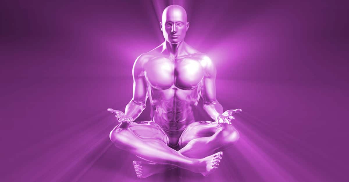 A man practicing personal development plan while seated in a lotus position wearing purple attire.