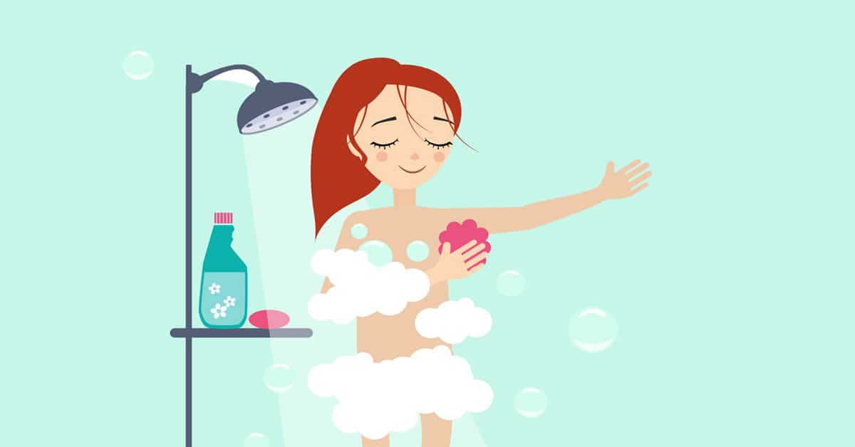 A woman indulges in self-care while taking a shower with soap and bubbles.