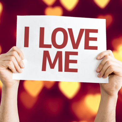 Hands holding up sign that says 'I love me'