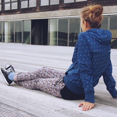 A woman making a mistake while sitting on a wooden deck.
