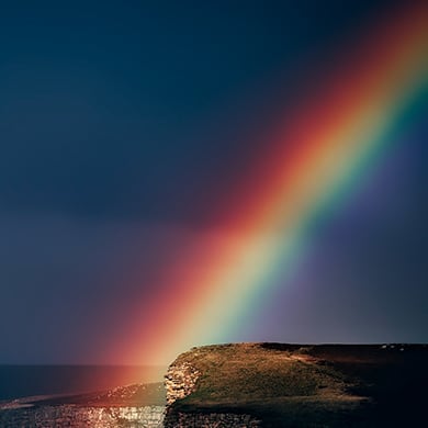 Rainbow over a ocean night sky