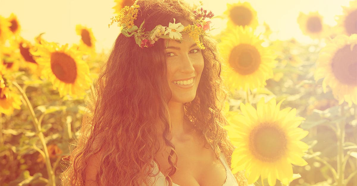 A radiant woman surrounded by sunflowers, harnessing the power of the law of attraction.