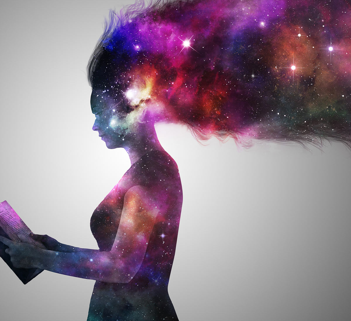 Girl reading a book with a beautiful cosmic universe showing within her silhouette