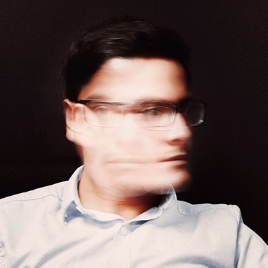 Blurred image of a man shaking his head quickly side to side