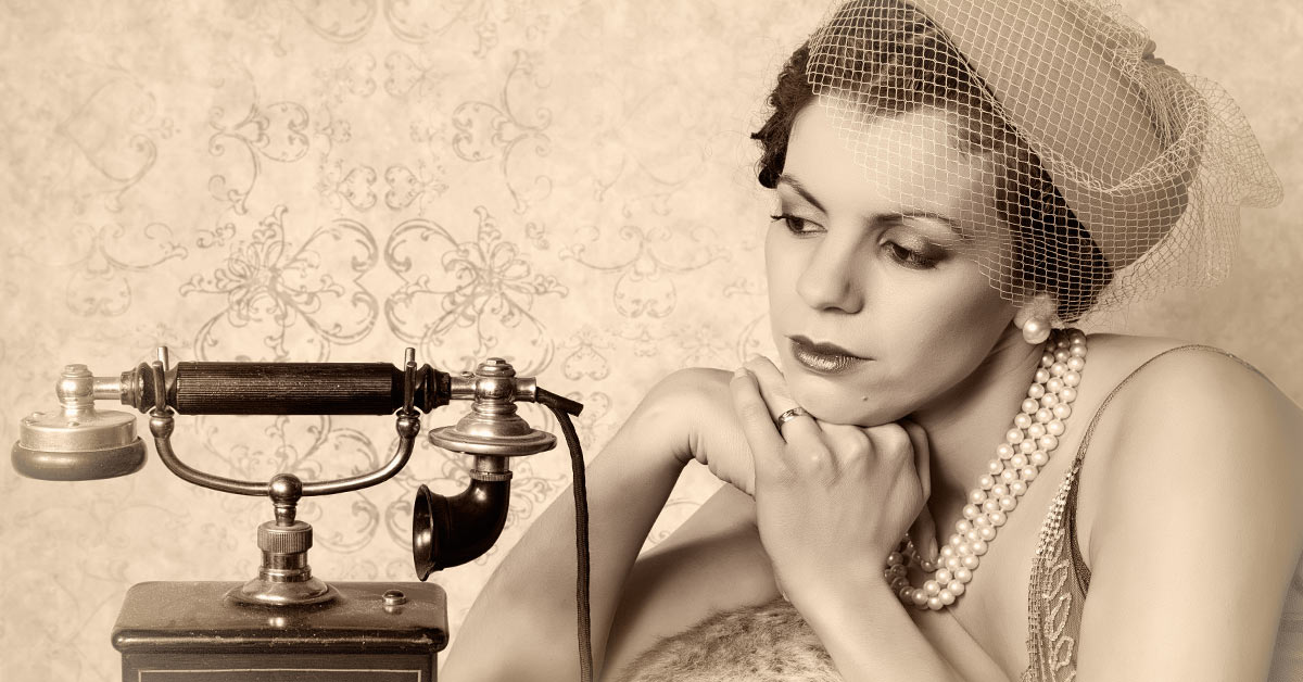 A woman with foundational beliefs is sitting next to a telephone.