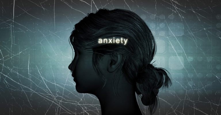 A woman's head with the word anxiety, depicting cognitive distortions.