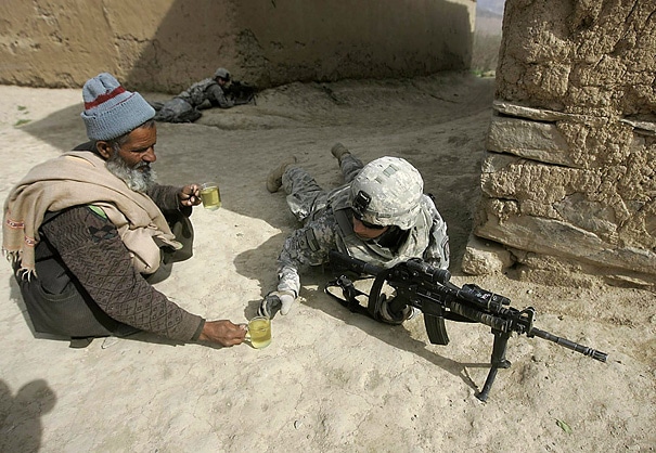 An Afghan man offers tea to a thirsty fighting soldier.